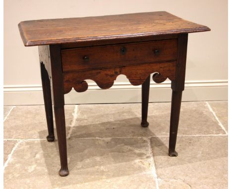 A mid 18th century oak side table, the twin plank moulded and oversailing top, above a single oak lined lip moulded, frieze d