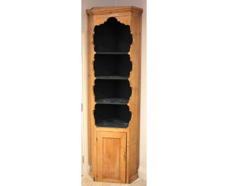 A Victorian pine freestanding corner cupboard, the moulded cornice over a painted interior with three open shelves, above a s