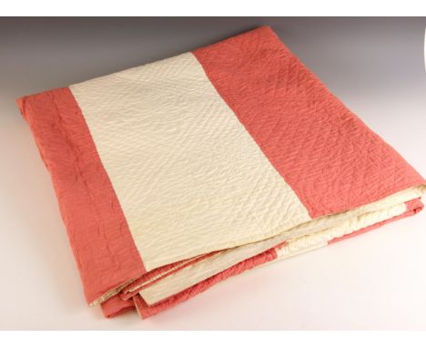 A pink and white striped quilt of large proportions, possibly Durham, late 19th or early 20th century, the broad striped fron