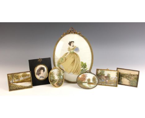 An oval silk work full length portrait of a young lady carrying flowers in a landscape, 23.5cm x 18cm, in oval glazed easel f