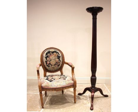 An early 20th century mahogany torchere plant stand, the tapering reeded column extending to three cabriole supports and poin