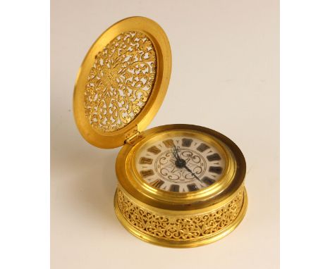 A Jaeger Recital eight day travelling alarm clock, the gilt metal hinged filigree case in the form of a table top drum clock,