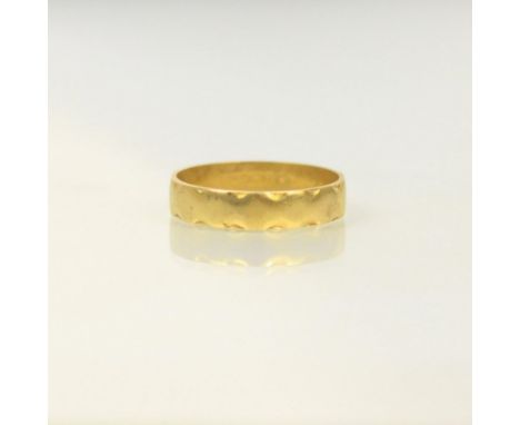 An 18ct yellow gold wedding band, with crimped edges, stamped 'S&amp;W' London, possibly 1972, ring size P, 3gms