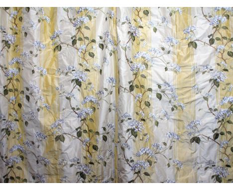 A pair of bespoke curtains in Colefax & Fowler 'Summerby Silk' fabric, featuring climbing lace cap hydrangeas on a yellow and