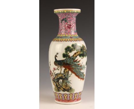 A Chinese porcelain famille rose Republic style vase, decoarted with a peacock perched upon a rocky outcrop beneath a pine tr