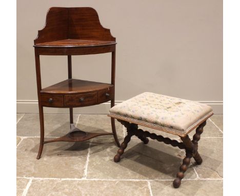 A George III mahogany corner washstand, of typical bowfront form, the second tier with a single frieze drawer, upon slender o