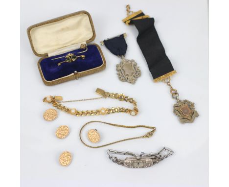 A selection of jewellery, including a gold plated paste pearl bracelet, a white metal fob medal upon black silk ribbon with y