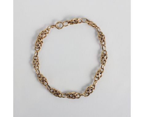 An early 20th century yellow metal bracelet, the stylised Celtic designed links with bolt ring fastener, indistinctly stamped
