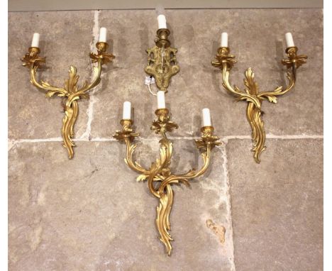 A pair of gilt metal Rococo twin branch wall light fittings, each formed as intertwined foliate branches, 42cm high, along wi