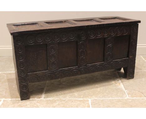 A 17th century and later oak coffer, primarily a six plank coffer on 'V' cut end supports, with associated four panel hinged 