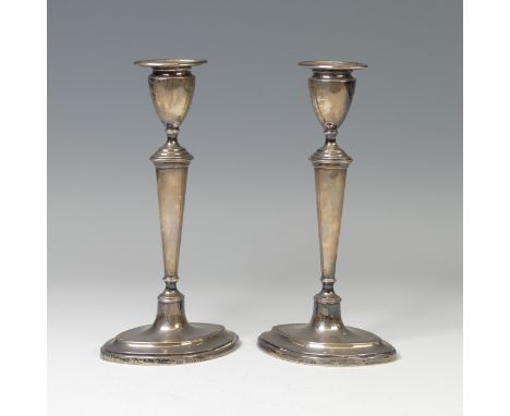 A pair of Edwardian silver Candlesticks, by Thomas A Scott, hallmarked Sheffield, 1908, in the George III style with weighted