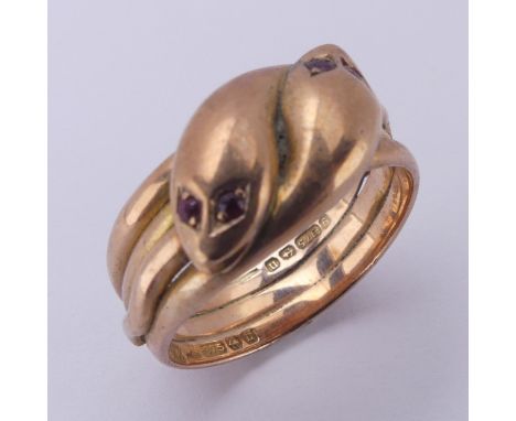 A 9ct rose gold double snake Ring, with heads conjoined at the front each with ruby set eyes, hallmarked Birmingham 1912,Size