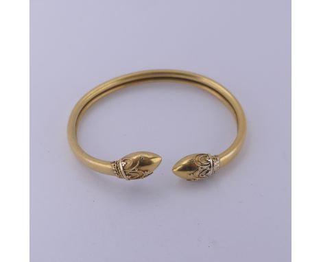 An antique Etruscan Revival style Bangle, unmarked, tested as probably 15ct gold,old repair to one finial, total weight 8.5g.