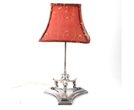 A silver-plated table lamp with triform base supporting three hooved feet capped with models of owls with acanthus leaf above