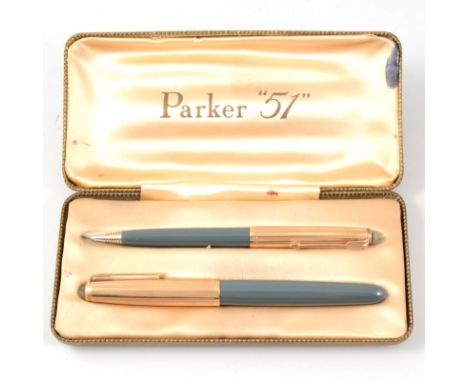 A vintage boxed Parker "51" fountain pen and ball point pen set, gold-plated caps with vertical lined design, grey/green tone