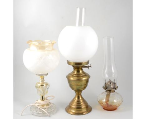 Modern brass oil lamp, with chimney and opaque shade, 51cm; another oil lamp and a table lamp. (3)