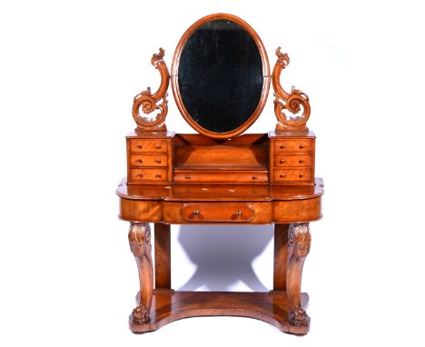 Victorian mahogany Duchess dressing table, oval mirror with carved supports, above trinket drawers, bowfront base with a frie