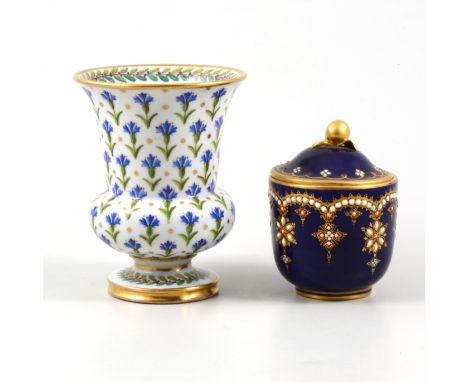 A Sevres campana shaped vase decorated with cornflowers with gilded rim, foot and highlights, 11cm, a small Sevres blue lidde