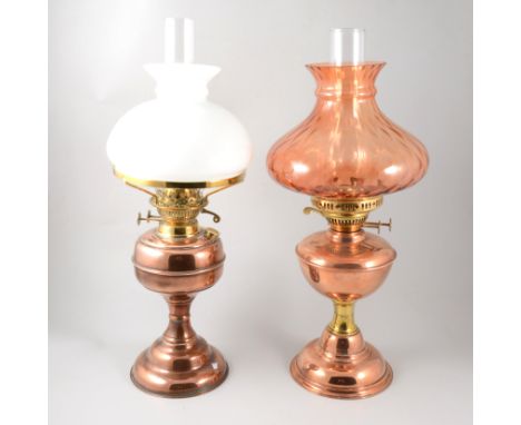 Copper oil lamp with chimney and opaque shade, 54cm; another with a tinted glass shade.
