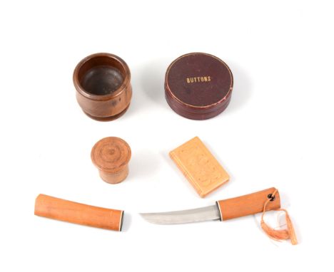 A tray with small items of treen, snuff box, mirror, napkin ring, carved needle holders, a "Button" box, silver coloured stud
