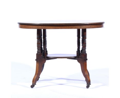 Late Victorian walnut occasional table, oval top with a moulded edge, raised on turned and ringed columns, joined by a shelf,