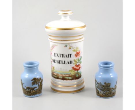 A white ceramic drug jar "Extrait de Bellad", 26cm, a pair of pale blue vases with a transfer of a shooting party to one and 