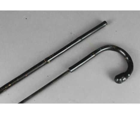 A Bamboo sword stick the blade being held in black lacquered bamboo cane, the 48cm blade bears no markings.