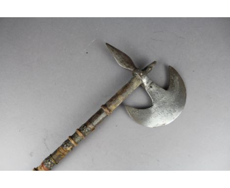 A Tribal snakeskin and leather bound handled axe having crudely engraved head.