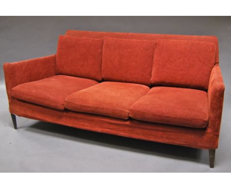 A 'B and B Italia' rectangular sofa, upholstered in red fabric, on tapering feet. Retains label. Please note the model for th