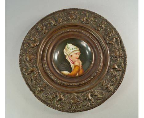 A French porcelain dish, late 19th/early 20th century, decorated with a portrait of a lady , mounted in a pressed copper fram