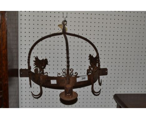 A cast metal wall hanging light/hook, in medieval style