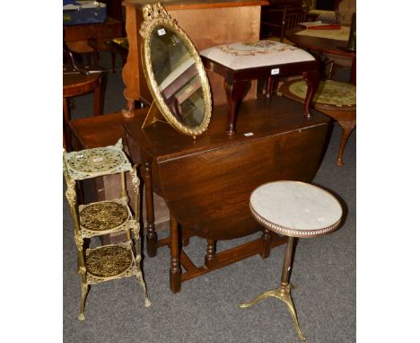 A reproduction gilt and marble wine table;  a gilt metal three tier stand, pierced with foliate scrolls;  an oval mirror;  a 