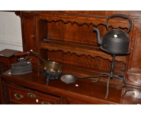 Metal Ware - a cast iron kettle on trivet;  a large ladle;  a flat iron;  a cast iron saucepan