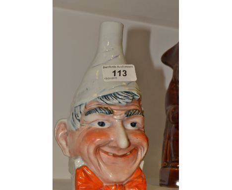 A Saxe Novelty mask vase, in relief with a comical man, wearing a red bow tie, wearing a tall pointed hat, 20cm high, printed