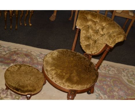 A late 19th century nursing chair, deep buttoned back, fluted side spindles, circular stuffed over seat, tapered  legs, c.189