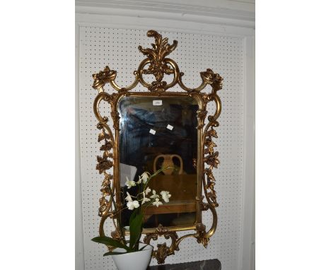 A rectangular mirror, the gilt frame with lofty leaf and scroll cresting, sides and base, 20th century
