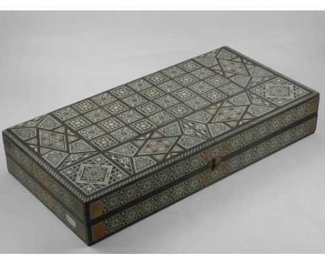 A Damascus ware chess and backgammon set, veneered in exotic hardwood and bone, together with backgammon pieces. L.50cm 