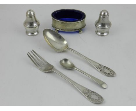 An early 20th century silver christening fork and spoon, Sheffield, together with two baluster peppers and an oval silver pla