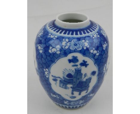 A small Chinese blue and white porcelain vase, decorated with vignettes of flowers, birds and ornaments, amongst a floral pat