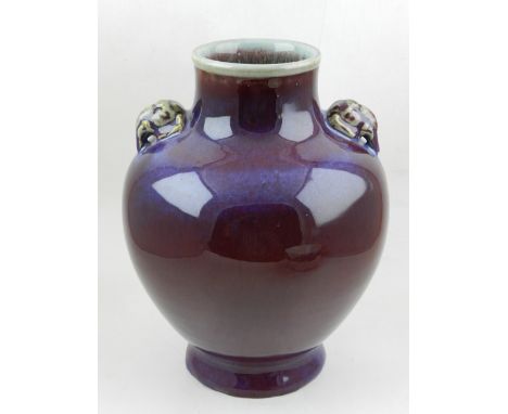 A Chinese flambe vase, of globular form, with two elephant head handles. H: 31cm