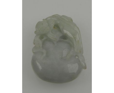 A Chinese white jade carving of a monkey atop a peach. 