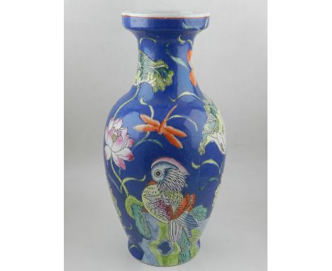 A Chinese porcelain baluster vase, decorated in the famille rose palette with a pair of Mandarin ducks amid large lotus flowe