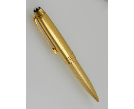 A Montblanc Meisterstuck gilt ballpoint pen, with engine turned design. 