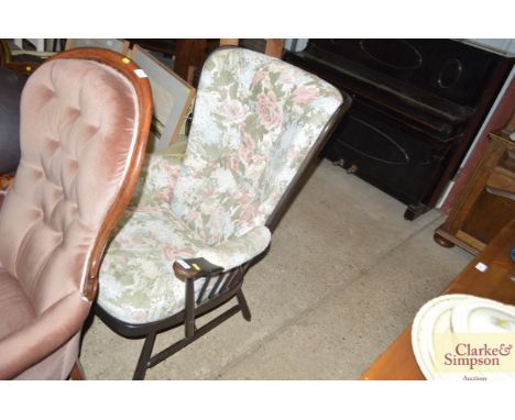 An Ercol type armchair with floral upholstery