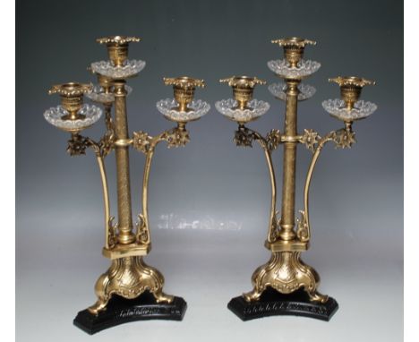 A PAIR OF 20TH CENTURY THREE BRANCH / FOUR LIGHT LACQUERED BRASS CANDELABRA, the four sconce with original glass drip trays, 
