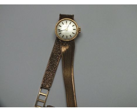 A HALLMARKED 9 CARAT TISSOT WRIST WATCH, having silvered dial and baton hour markers, approx weight 19.7g, Dia 3.25 cm