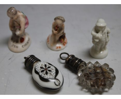 A MINIATURE CUT GLASS SCENT BOTTLE WITH WHITE METAL MOUNTS, overall H 3.5 cm, together with a porcelain miniature scent bottl