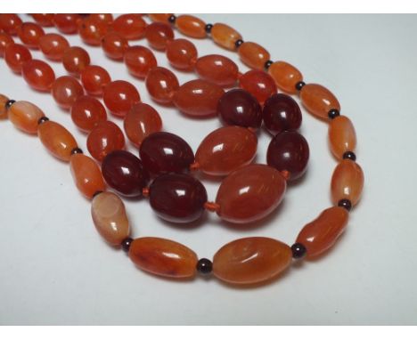 A VINTAGE DOUBLE STRAND GRADUATED BEAD  AND CHERRY AMBER NECKLACE, comprising a selection of cherry amber and polished agate 