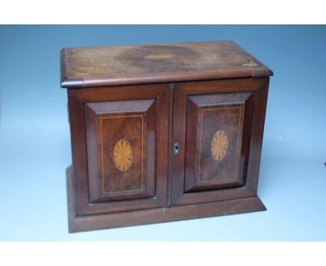 AN EDWARDIAN WALNUT SMOKERS CABINET WITH INLAID SATINWOOD DECORATION, the twin doors and hinged lid opening to a part fitted 