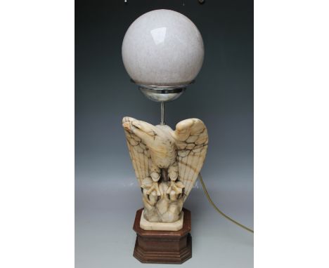 AN ART DECO ALABASTER EAGLE TABLE LAMP, raised on an oak plinth, with a marbled globe shade, overall H 66 cm